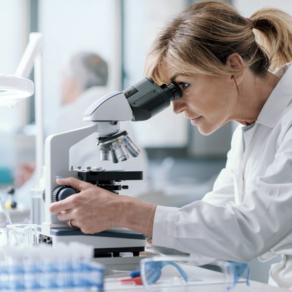 Person using a microscope in a lab