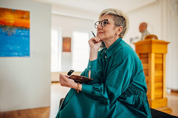Woman in a teal dress looking into the distance