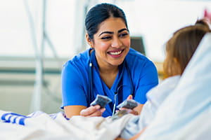 Nurse attending to young child in a hospital bed