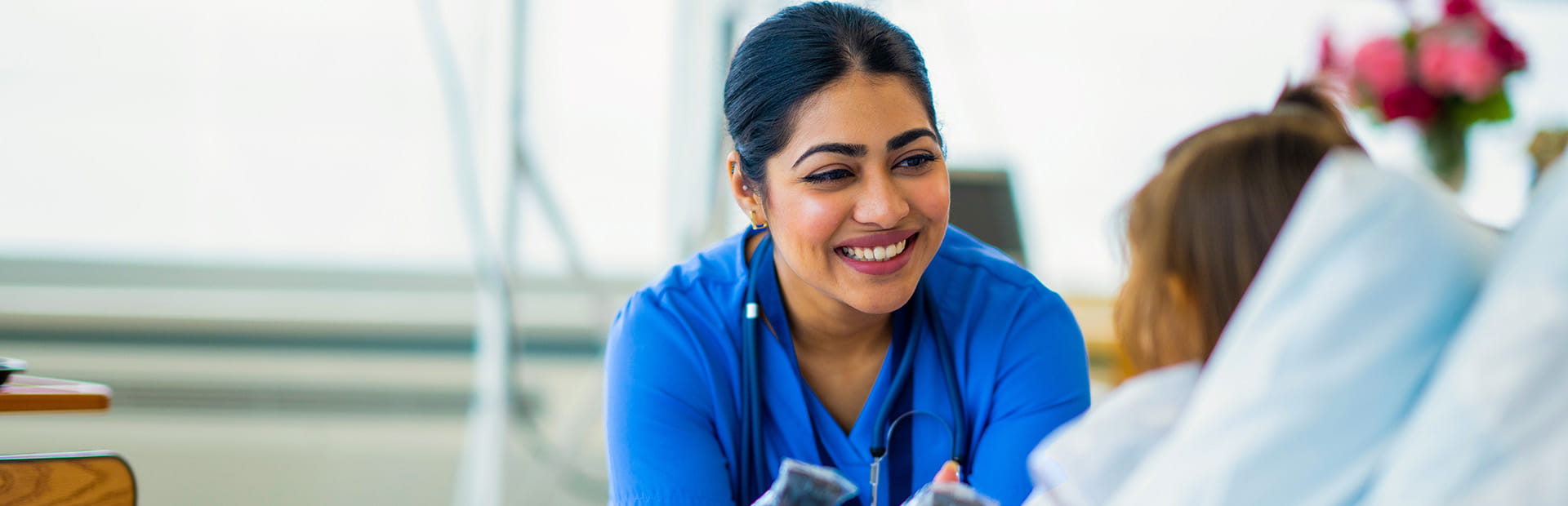 Nurse attending to young child in a hospital bed