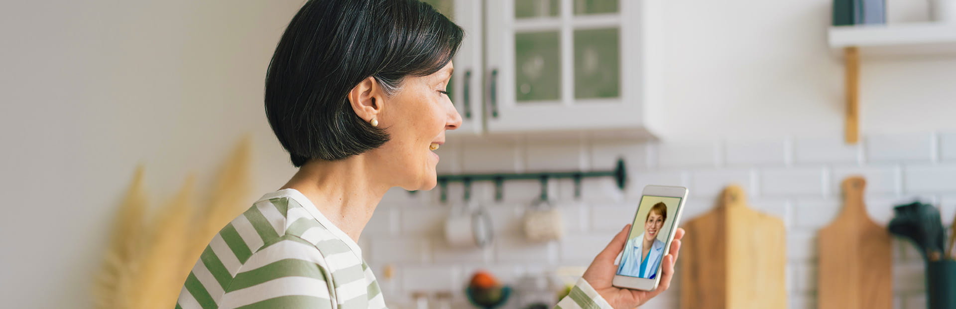 Woman in a striped top talking with a medical professional on video call