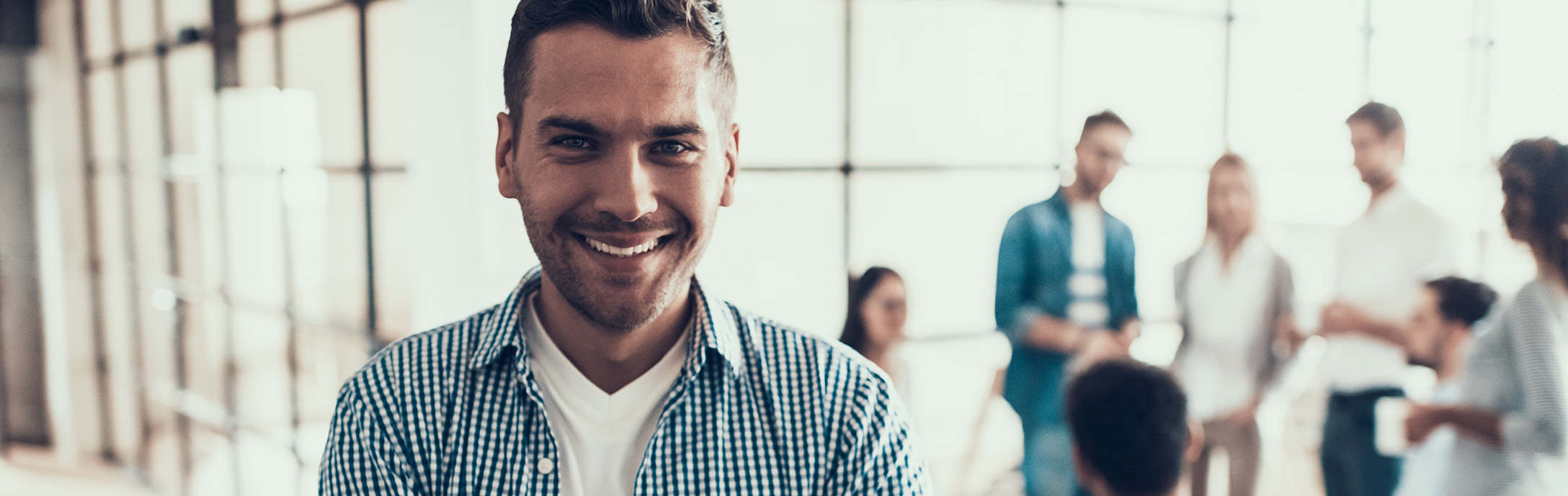 Man smiling in front of a group of people