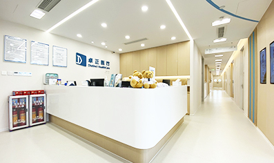 The reception desk of Guangzhou Zhujiang New Town Clinic with a corridor to the right